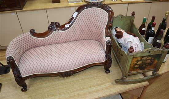 A miniature chaise longue with doll and painted crib